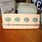 A Dutch green and cream kitchen towel rack.