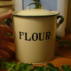 Very small green and cream enamelware flour bin.