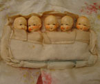 Antique baby dolls in bed.