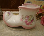 A pretty antique shoe with rose decoration.